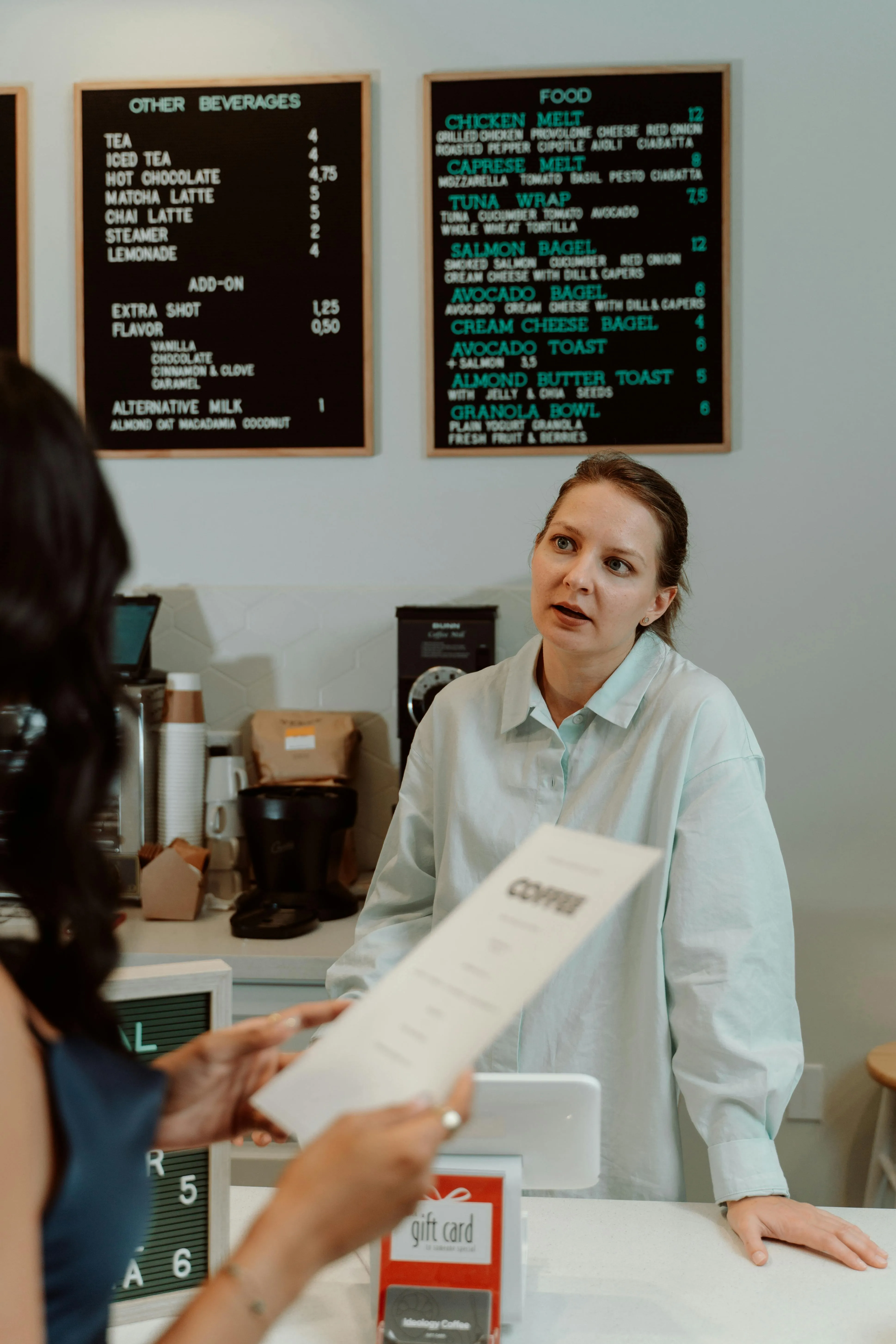 A traditional paper menu compared to a modern digital menu ordering system.