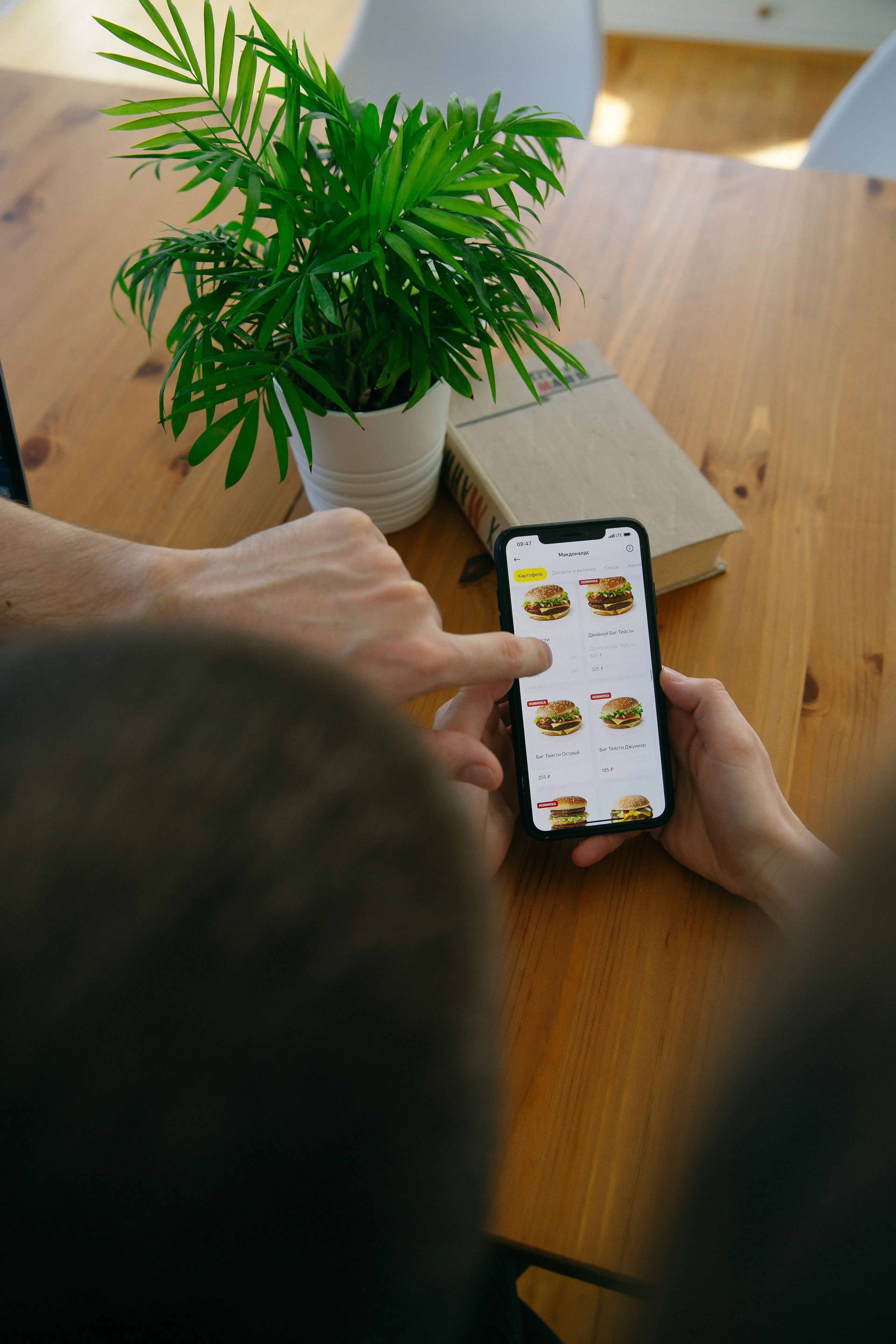 Customer comfortably ordering food and drinks on their smartphone using a QR code digital menu.