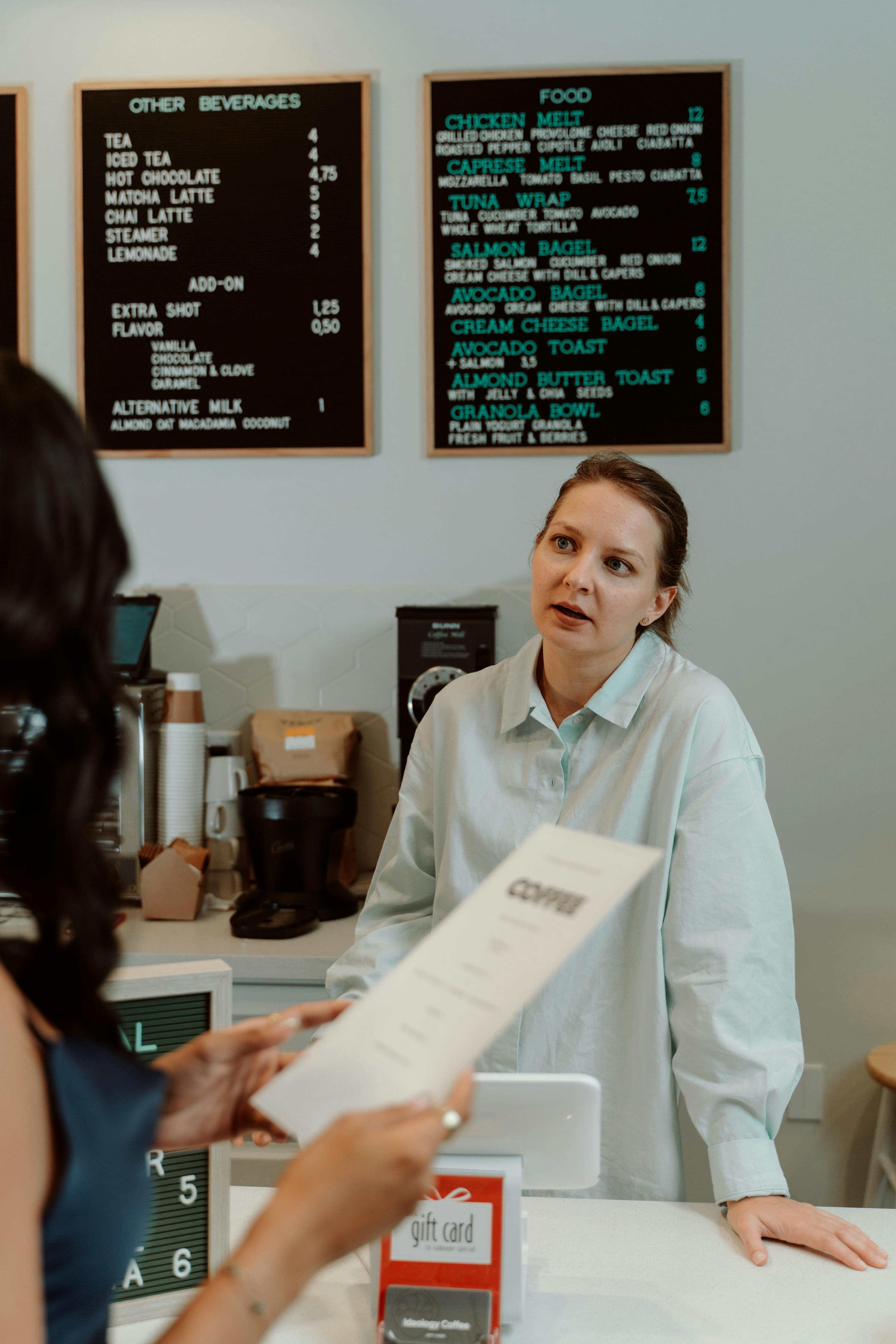 A traditional paper menu compared to a modern digital menu ordering system.